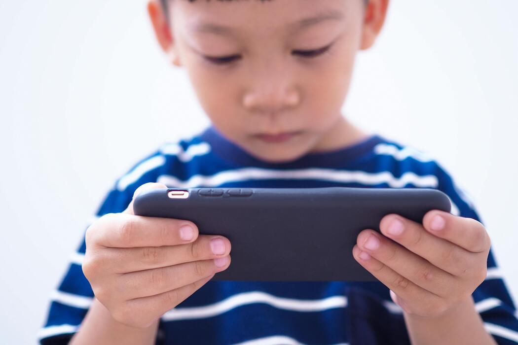 asian children in the age of social networks that focus on phones or tablets free photo